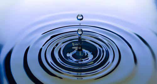 A drop falling into water